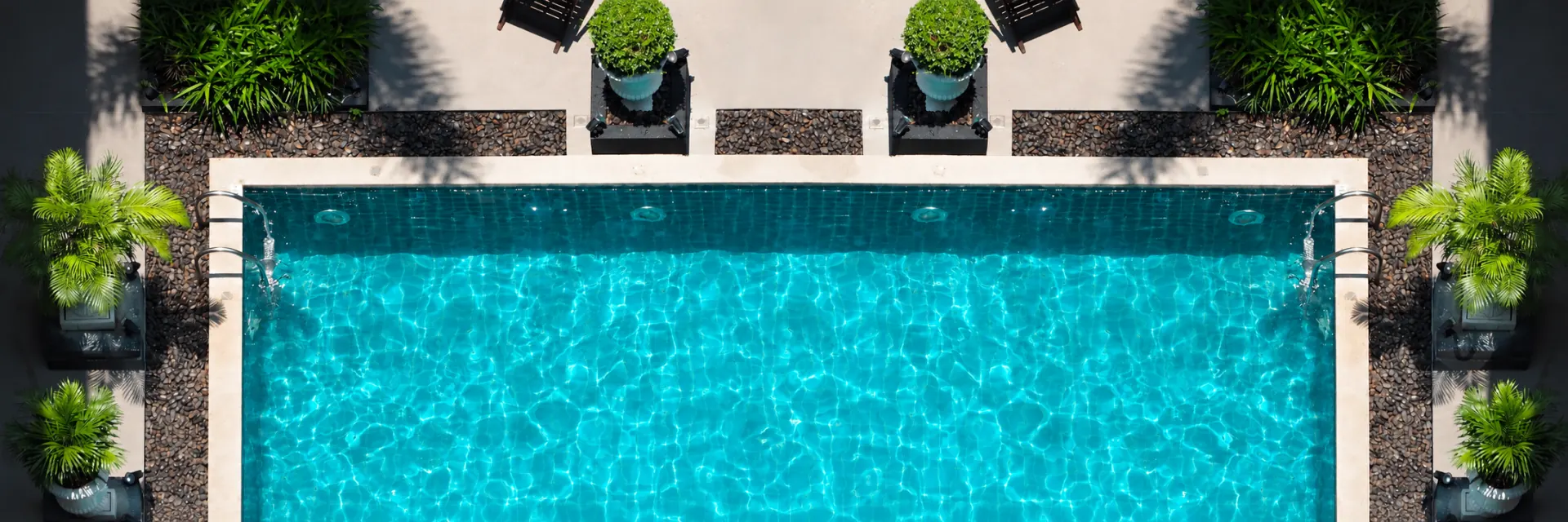 Aerial view of a clean, crystal-clear swimming pool maintained by Brisbane Pool Robotics.